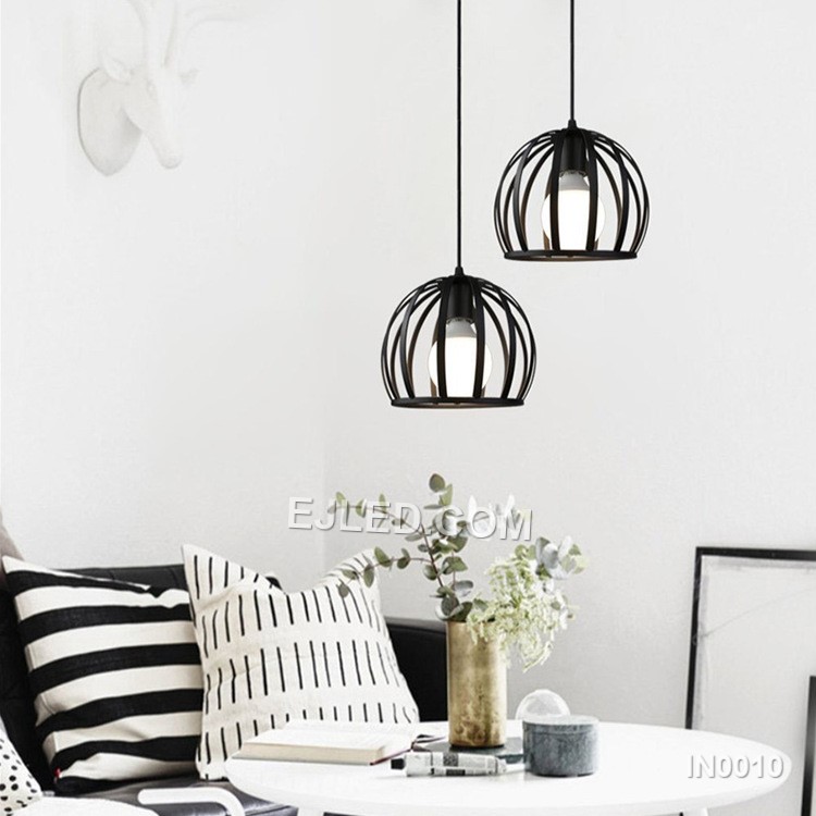 This IN0010 iron pendant light features a solid, semi-circular dome shade with a matte black exterior and white interior, holding a single E27 lamp. It hangs by a black cable. - view 4