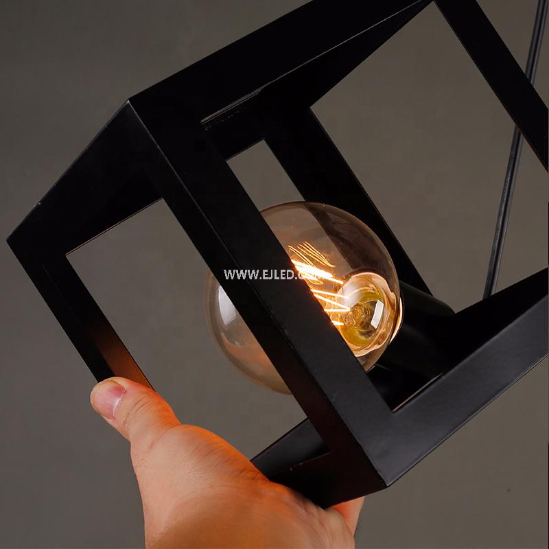 This IN0008 steel pendant light presents an open cube cage design, finished in matte black, with a single E27 lamp holder inside. It hangs from an adjustable black cable and round ceiling plate. - view 3
