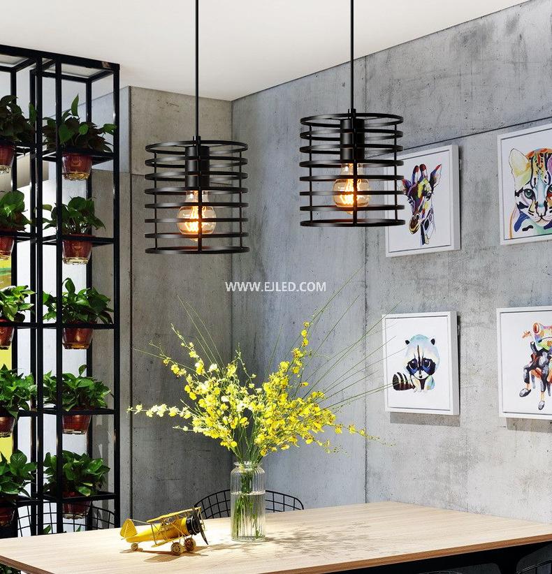 This cylindrical pendant light distinguishes itself with a unique spring coil design, crafted from black-finished iron. Its single, exposed lamp holder provides direct illumination while making the bulb a visual feature. - view 6
