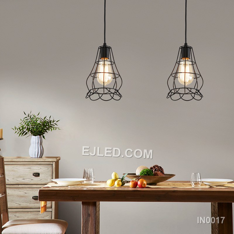 The black powder-coated finish on this iron pendant light highlights its open bell-shaped cage. Multiple thin, vertical strips create an airy structure, allowing a single bulb to cast direct, unobstructed light. - view 4