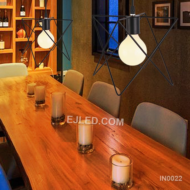 Model IN0022 is an iron pendant light distinguished by its unique triangular prism cage, finished in matte black. This geometric design provides direct, open illumination, suitable for adding a modern industrial accent to various commercial or residential spaces. - view 4