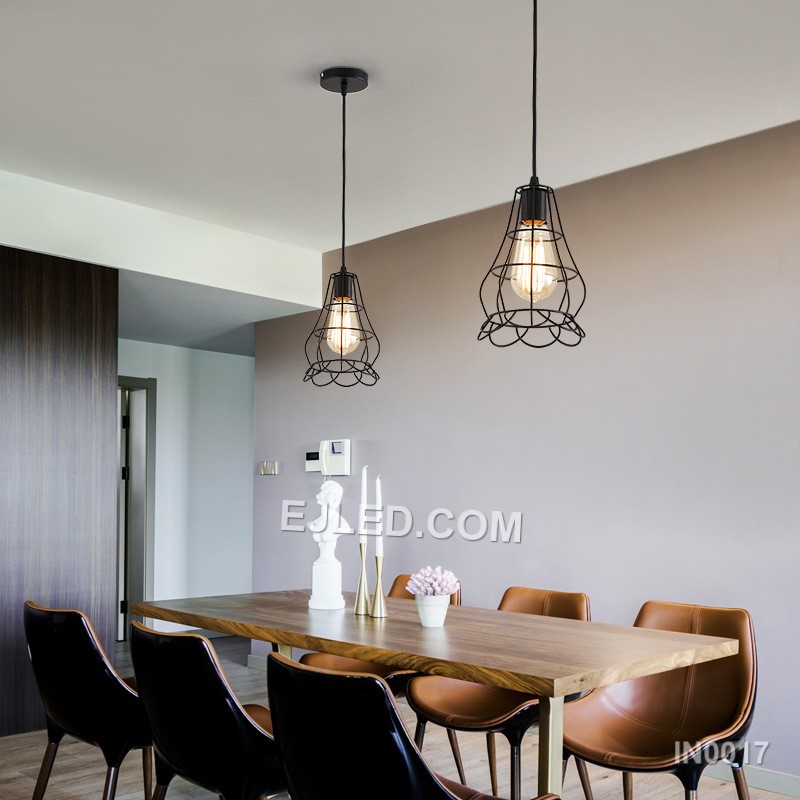 The black powder-coated finish on this iron pendant light highlights its open bell-shaped cage. Multiple thin, vertical strips create an airy structure, allowing a single bulb to cast direct, unobstructed light. - view 5