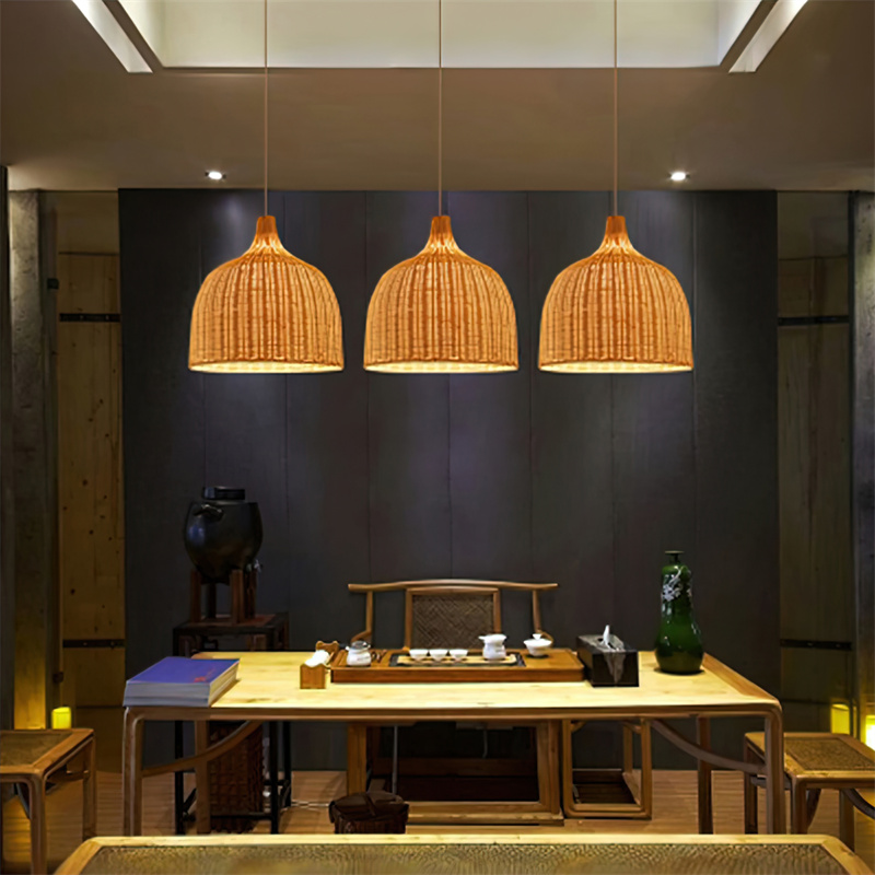A single lamp bell-shaped pendant, hand-woven from natural rattan, creates a warm, diffused light. Its open weave and earthy texture make it suitable for intimate dining areas, hotel lobbies, or relaxed retail environments seeking a natural aesthetic. - view 5