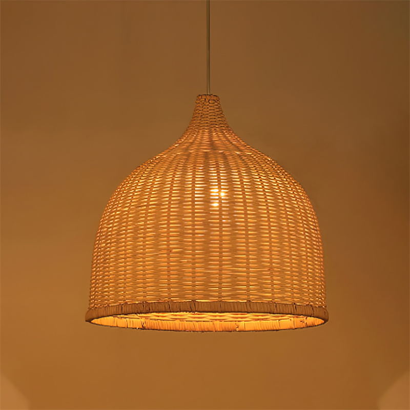 A single lamp bell-shaped pendant, hand-woven from natural rattan, creates a warm, diffused light. Its open weave and earthy texture make it suitable for intimate dining areas, hotel lobbies, or relaxed retail environments seeking a natural aesthetic. - view 2