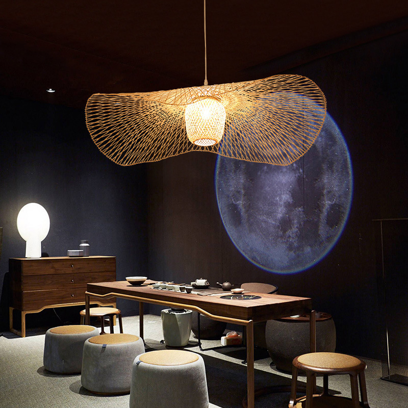 Model RT0033 features a wide, conical bamboo pendant shade, hand-woven with a natural finish. Its expansive open bottom directs a broad light spread, ideal for illuminating larger surfaces like dining tables or reception desks. - view 6