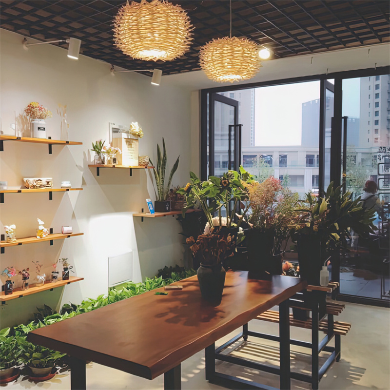 The RT0030 pendant light offers a distinctive globe-like silhouette, crafted from tightly woven wooden strips. Its enclosed design provides soft, diffused illumination suitable for creating an ambient glow in various settings. - view 4