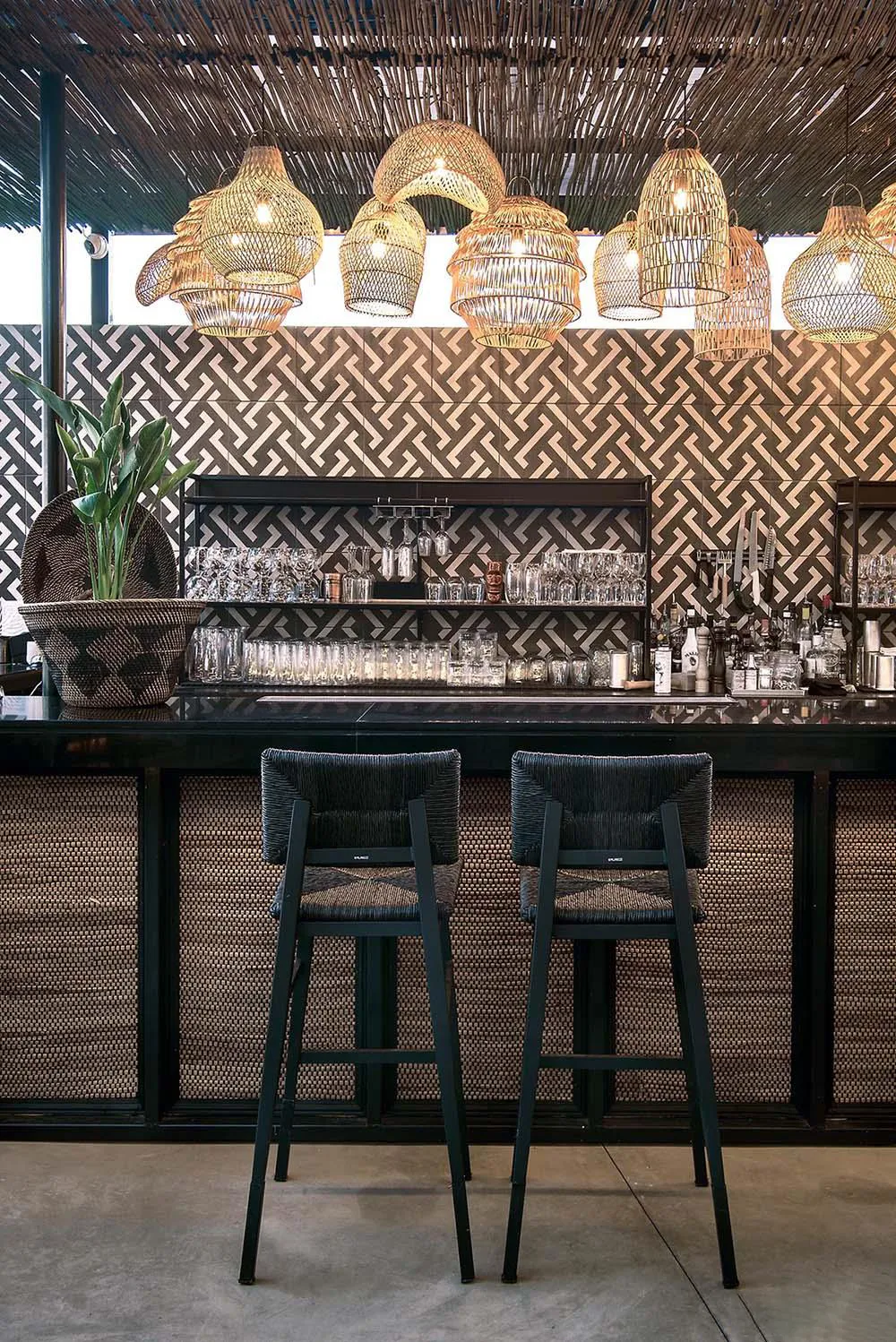 Screens made of reeds add beachy aesthetic to this bar and restaurant