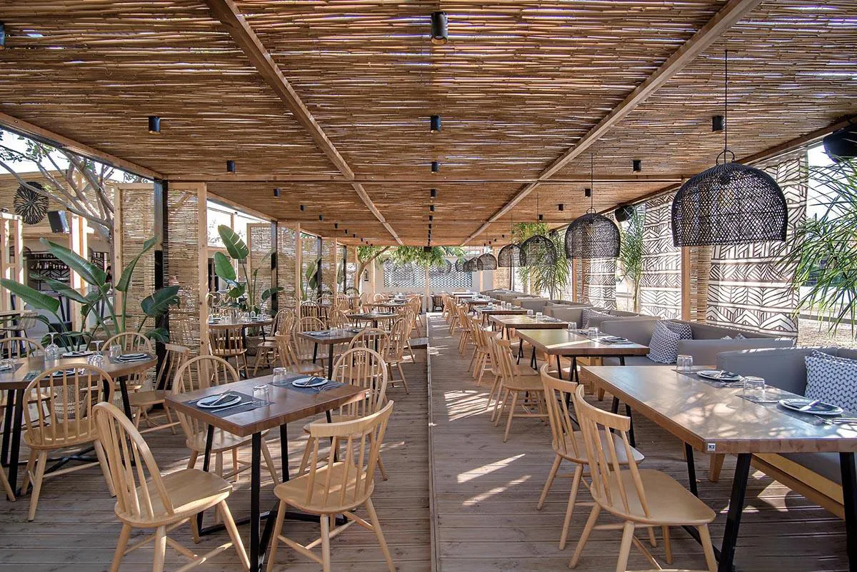 Screens made of reeds add beachy aesthetic to this bar and restaurant