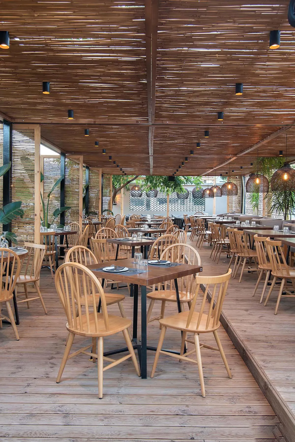 Screens made of reeds add beachy aesthetic to this bar and restaurant