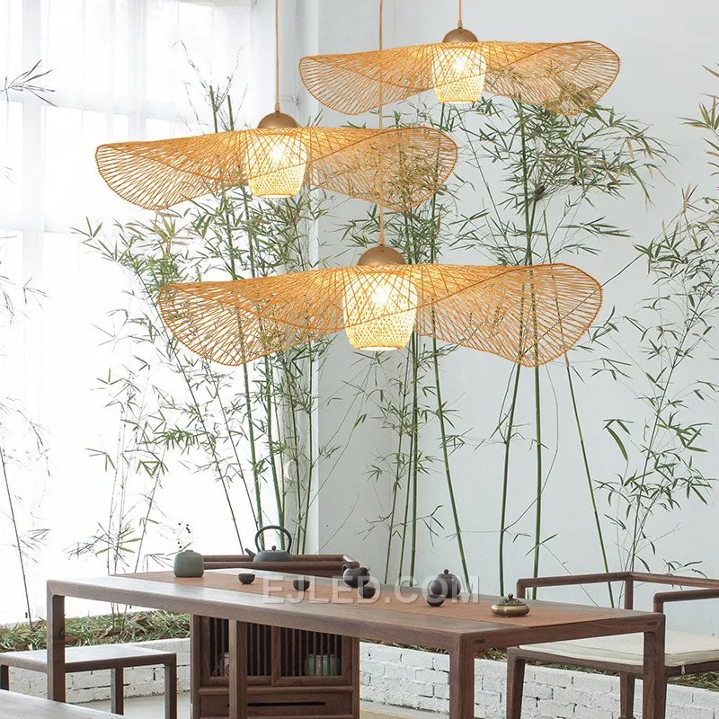 This bamboo pendant stands out with its unique, waisted bell silhouette, offering a departure from conventional dome or basket designs. Its dense weave directs light primarily downwards. - view 3
