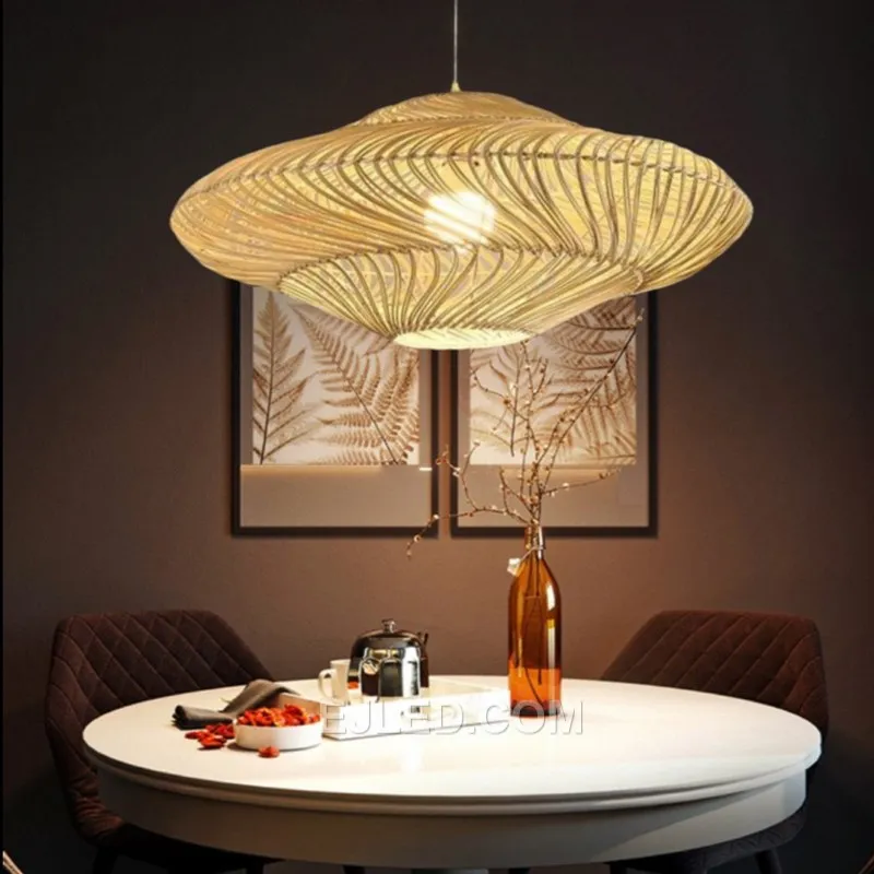 An elongated oval shape woven from natural bamboo distinguishes this pendant, which casts diffuse light through its open-weave construction and unique texture. - view 4