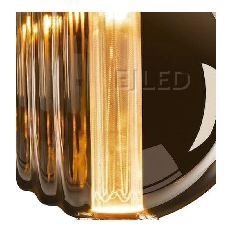 This amber glass light guide LED bulb features a ribbed shade design and an internal vertical light source, creating a warm vintage decorative effect. - view 3