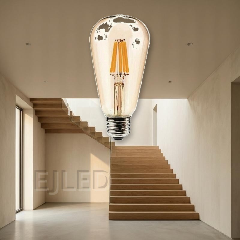 This clear glass teardrop lamp features visible LED filaments and a standard threaded metal screw base. It provides warm illumination for commercial and residential lighting projects. - view 4