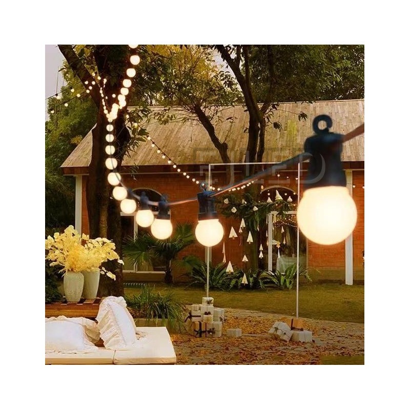 Outdoor dark blue plastic globe string lights featuring round white lamps suspended from a dark blue wire. Designed for exterior commercial and landscape decoration. - view 2