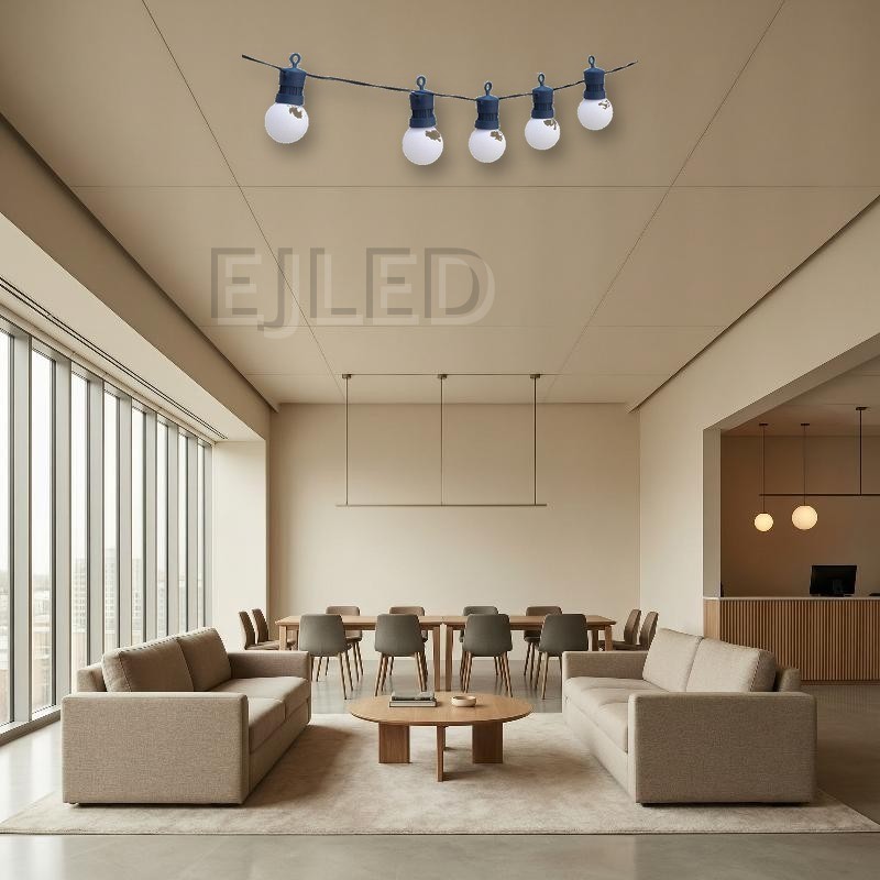 Outdoor dark blue plastic globe string lights featuring round white lamps suspended from a dark blue wire. Designed for exterior commercial and landscape decoration. - view 4