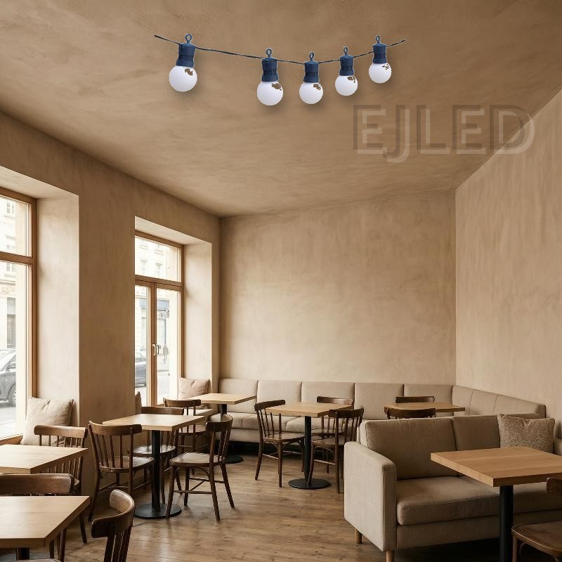 Outdoor dark blue plastic globe string lights featuring round white lamps suspended from a dark blue wire. Designed for exterior commercial and landscape decoration. - view 5