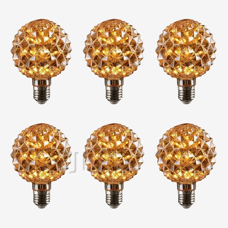 This amber glass bulb features a spherical shape with faceted crystal details and an Edison screw base, powered by interior LED lights. - view 5
