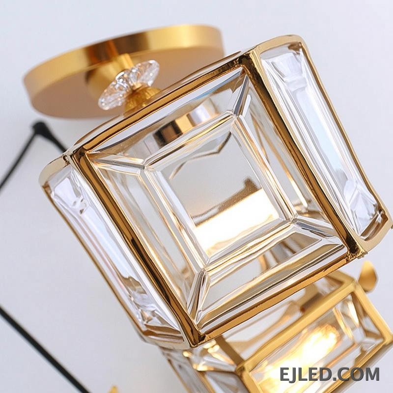 This fixture features three brass and clear glass pendant lights, each with an enclosed design, hanging from a single gold-finished canopy, casting a warm glow. - view 5