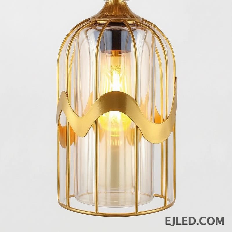 This pendant light features a clear glass cylindrical shade, capped with a sleek gold-finished brass element. It provides focused downward illumination from a single lamp, ideal for accent lighting or clustered arrangements. - view 5