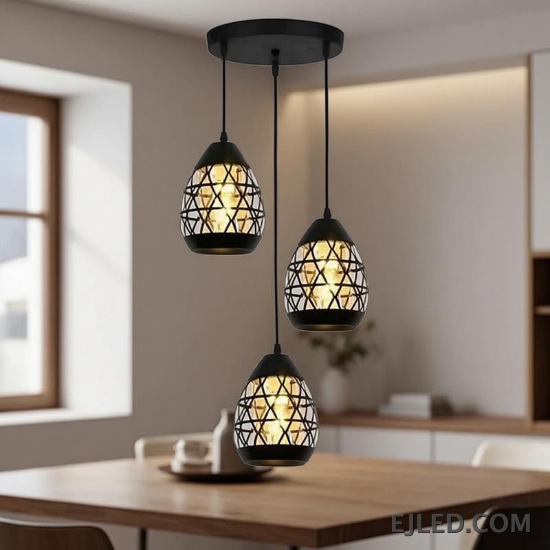 Constructed from black-finished iron, this geometric pendant light features an open, hexagonal cage design. It showcases a single exposed lamp, delivering ambient illumination in a modern industrial aesthetic. - view 3
