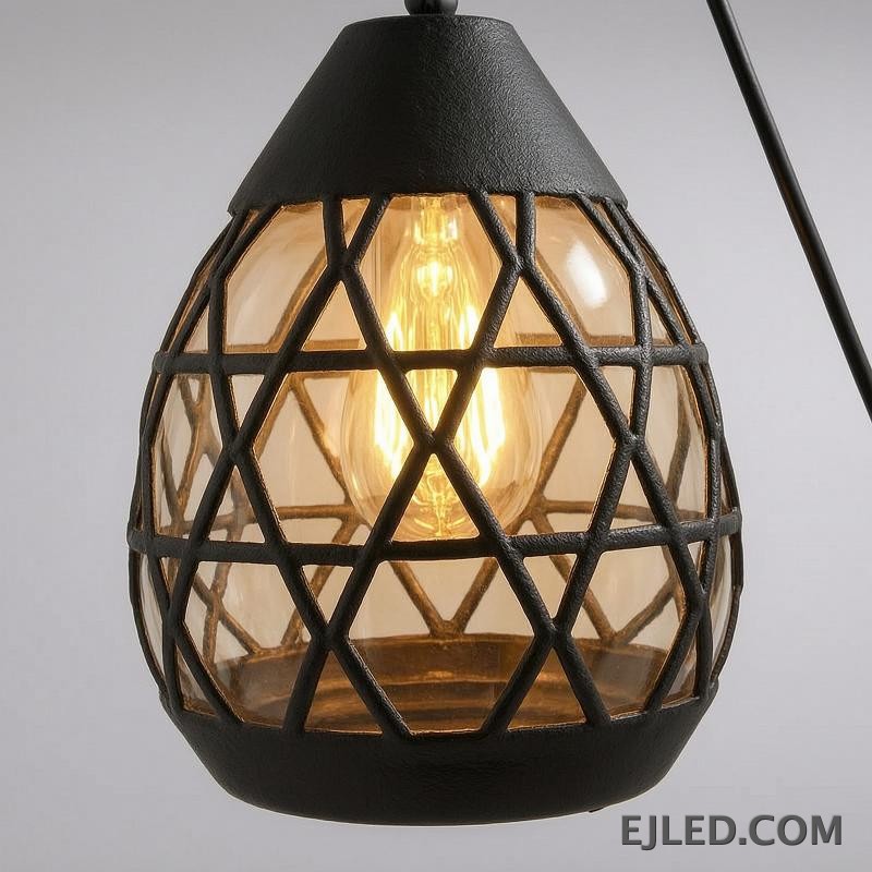 Constructed from black-finished iron, this geometric pendant light features an open, hexagonal cage design. It showcases a single exposed lamp, delivering ambient illumination in a modern industrial aesthetic. - view 5