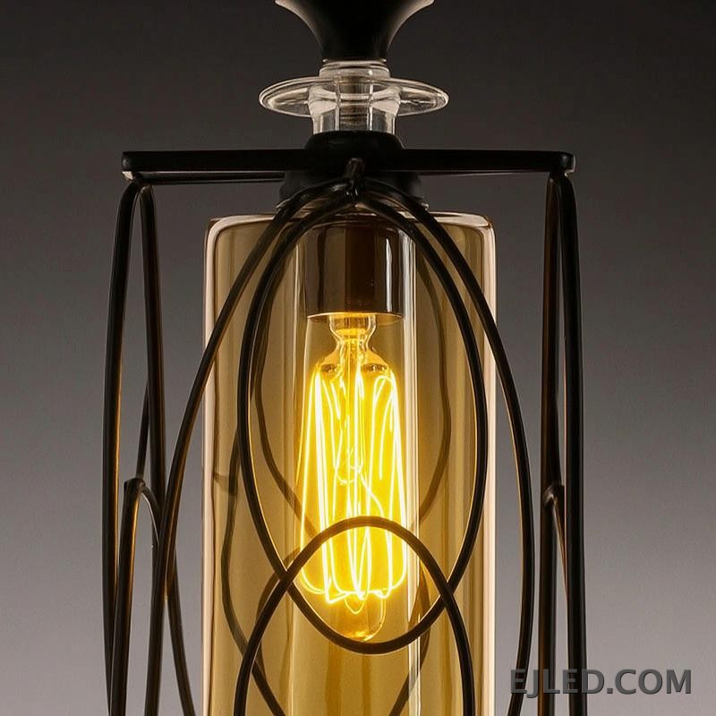 This three-lamp pendant fixture features black iron frames with cylindrical amber glass shades. Each lamp hangs from a black canopy, creating a unified lighting solution. - view 5
