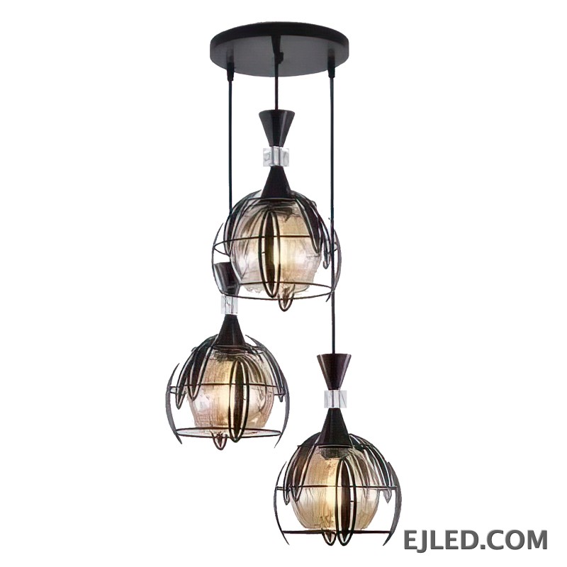 A clear spherical glass shade defines this pendant light, capped by a dark-finished iron element. It encases a single lamp, offering widespread ambient illumination ideal for contemporary and transitional interiors.