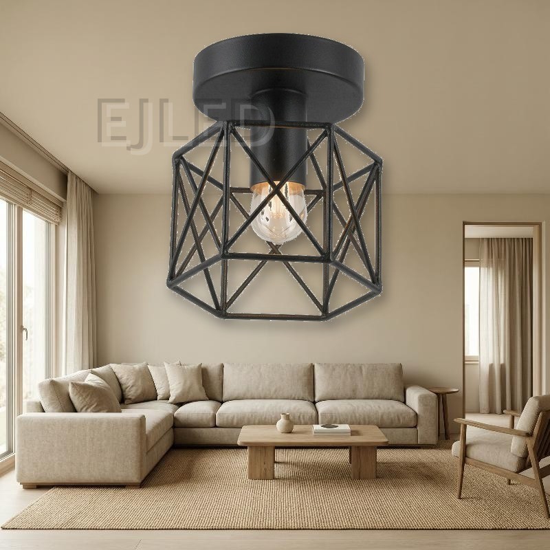 This surface mounted ceiling light features a black metal wire cage shade with a geometric framework and a single exposed bulb inside. - view 4