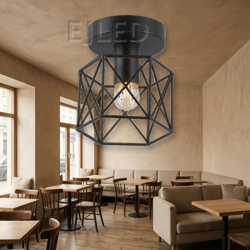 This surface mounted ceiling light features a black metal wire cage shade with a geometric framework and a single exposed bulb inside. - view 5