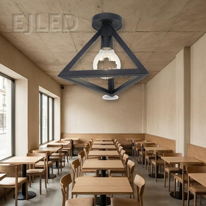 This black metal ceiling light features a geometric open frame shade housing a single exposed bulb. It mounts directly to the ceiling for a modern industrial look. - view 4