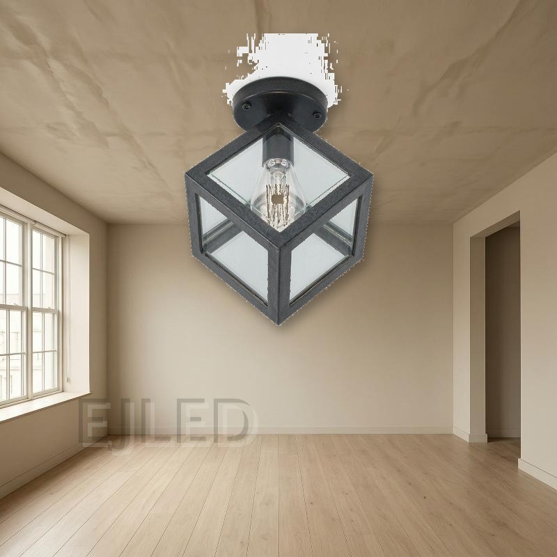 This black metal ceiling light features a geometric cube shade with glass panels and a single exposed vintage-style LED bulb. - view 4