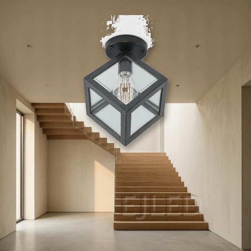 This black metal ceiling light features a geometric cube shade with glass panels and a single exposed vintage-style LED bulb. - view 5