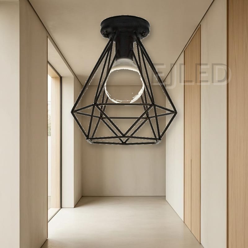 This black metal ceiling light features a geometric wire cage shade that exposes a single lamp. It mounts directly to the ceiling for a clean industrial look. - view 4