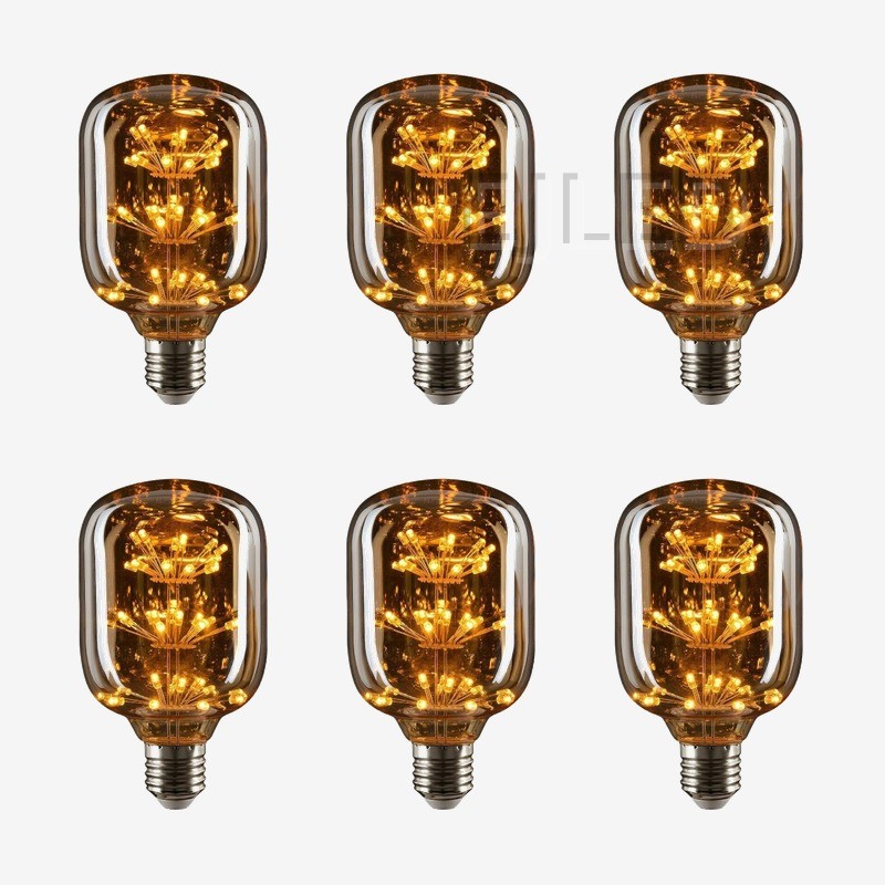 This amber glass starry LED bulb features multiple tiers of decorative interior lights inside a cylindrical glass shade with an Edison screw base. - view 5