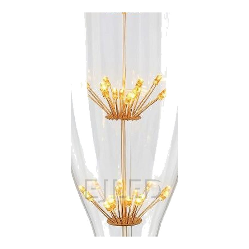 This clear glass starry LED bulb features a tall bottle shape and three vertical tiers of delicate firework style filaments connected to a standard screw base. - view 3