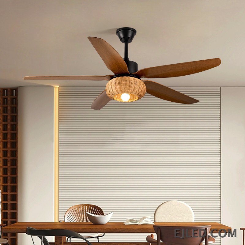 This ceiling fan light features five blades with a dark wood finish and a matte black ABS body. It includes a single light source housed within a spherical, open-weave rattan shade. - view 2