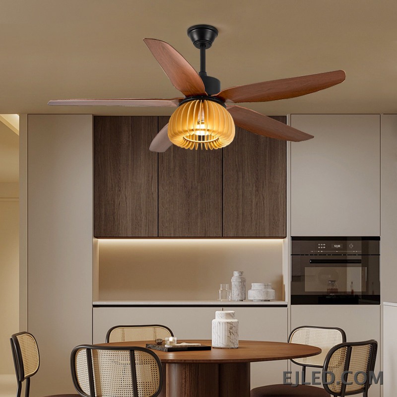 This ceiling fan light features five blades with a dark wood finish and a matte black ABS body. It includes a single light source housed within a spherical, open-weave rattan shade. - view 3