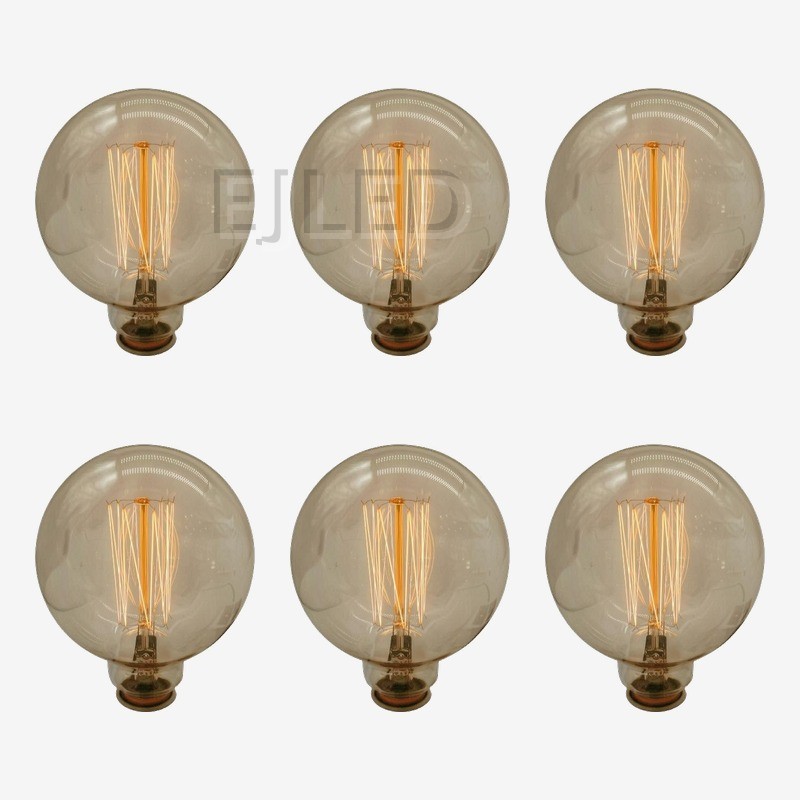 This amber glass incandescent bulb features a large round shape and exposed tungsten filaments inside a clear tinted globe. Model G80-40W-TF. - view 5