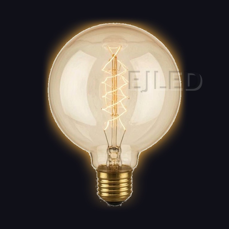 This amber glass G95 incandescent bulb features a spiral tungsten filament inside a large round globe. It operates on standard household voltage with a threaded brass base. - view 2