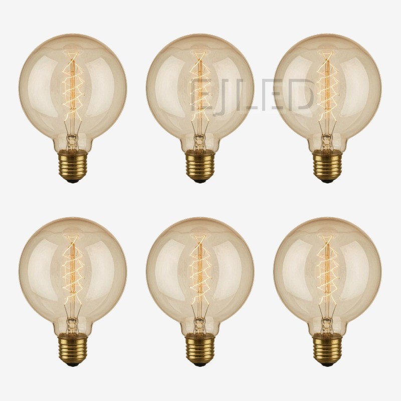 This amber glass G95 incandescent bulb features a spiral tungsten filament inside a large round globe. It operates on standard household voltage with a threaded brass base. - view 5