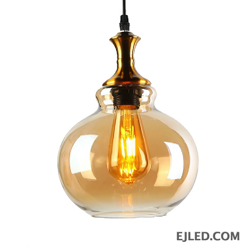 This glass pendant light features a spherical, amber-tinted shade that encloses a single exposed filament bulb. It hangs from a black suspension cord, complemented by a polished gold-finished metal cap. - view 3