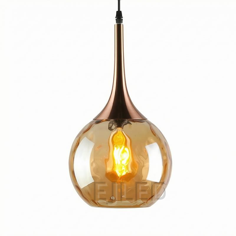This pendant light features an amber glass globe shade paired with a polished copper top and a single exposed bulb inside.