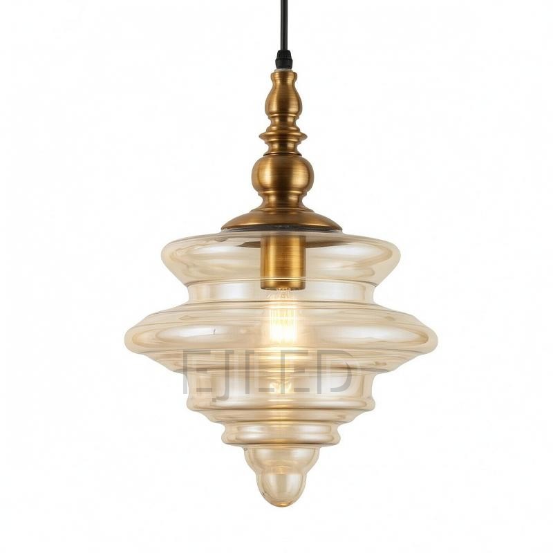 This distinctive amber glass pendant light features a sculpted shade suspended from an ornate brass finial. Its single lamp is enclosed within the translucent, bell-shaped glass, offering a warm glow for various interior settings.