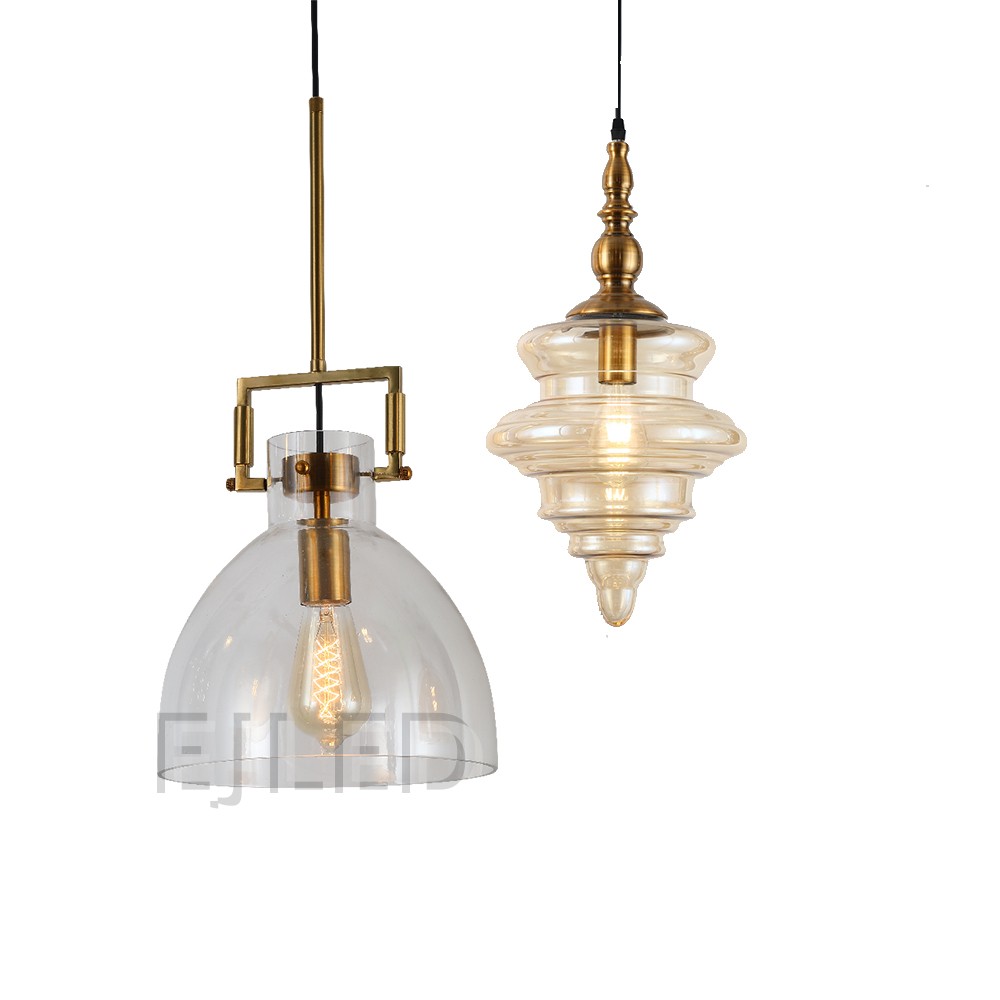 This distinctive amber glass pendant light features a sculpted shade suspended from an ornate brass finial. Its single lamp is enclosed within the translucent, bell-shaped glass, offering a warm glow for various interior settings. - view 6