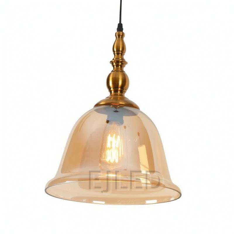 This pendant light features a bell-shaped amber glass shade suspended from an ornate brass-finished metal top. It uses one visible lamp for warm interior illumination.