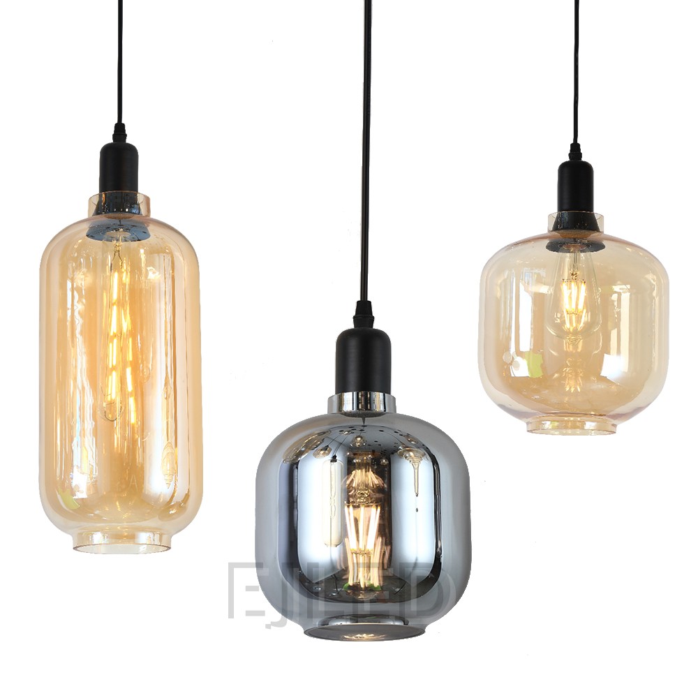 This amber tinted glass round pendant lamp features a visible vintage LED filament bulb inside an enclosed glass shade suspended by a black cord. - view 3