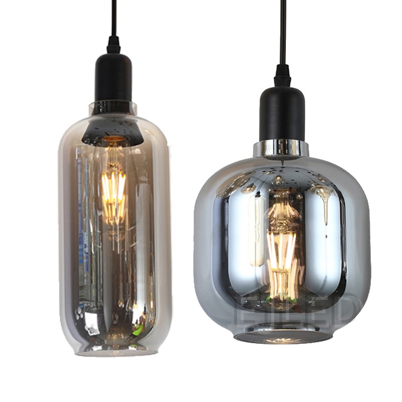 This amber tinted glass round pendant lamp features a visible vintage LED filament bulb inside an enclosed glass shade suspended by a black cord. - view 5