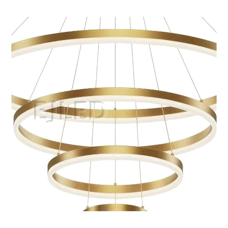 This multi-tier pendant fixture features four concentric gold circular rings suspended from a matching ceiling canopy by thin steel cables, creating a cascading modern light display. - view 3