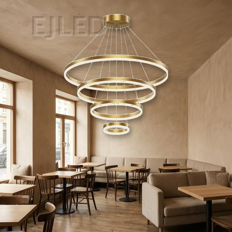 This multi-tier pendant fixture features four concentric gold circular rings suspended from a matching ceiling canopy by thin steel cables, creating a cascading modern light display. - view 4