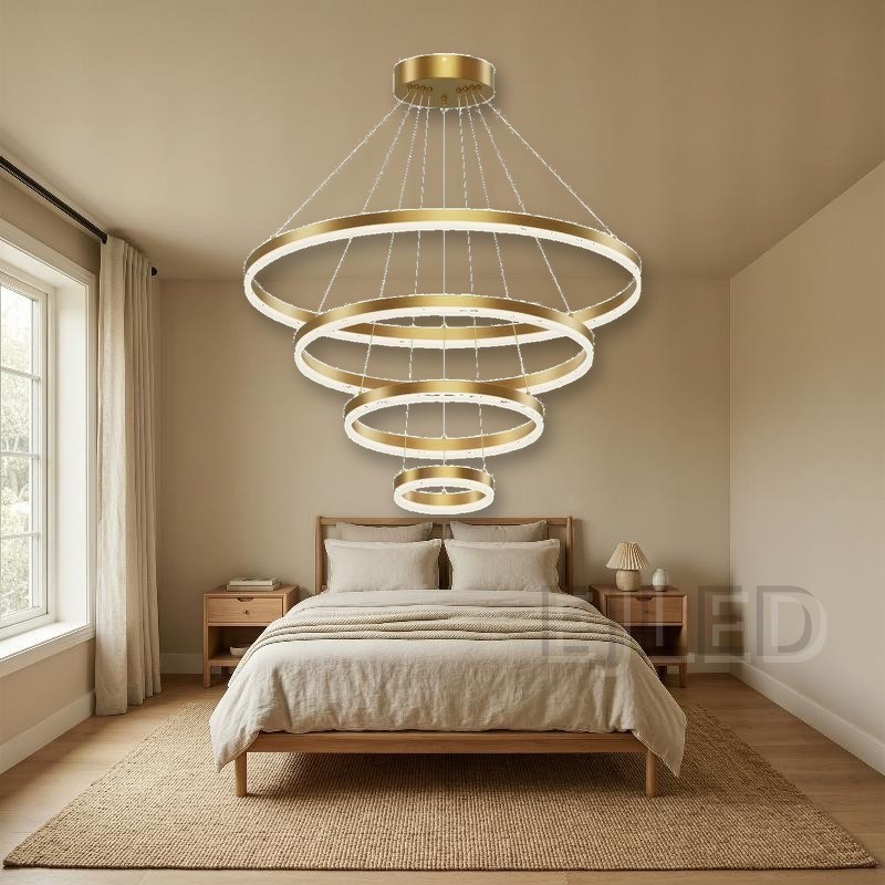 This multi-tier pendant fixture features four concentric gold circular rings suspended from a matching ceiling canopy by thin steel cables, creating a cascading modern light display. - view 5